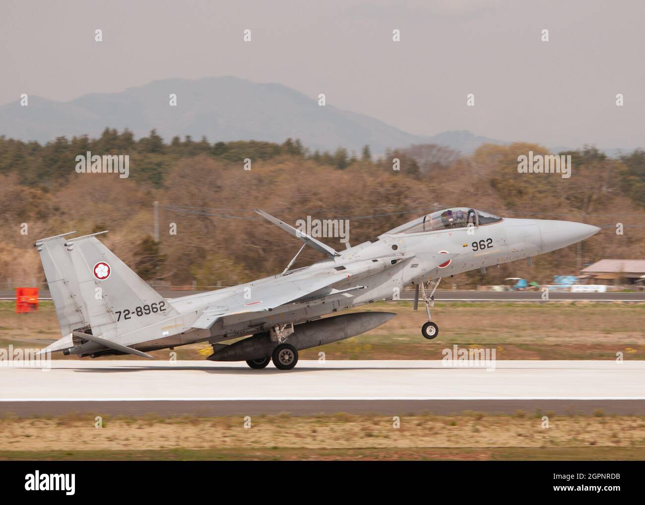 A Boeing F-15J Eagle of the Japan Air Self Defense Force landing at Hyakuri AB. Stock Photo