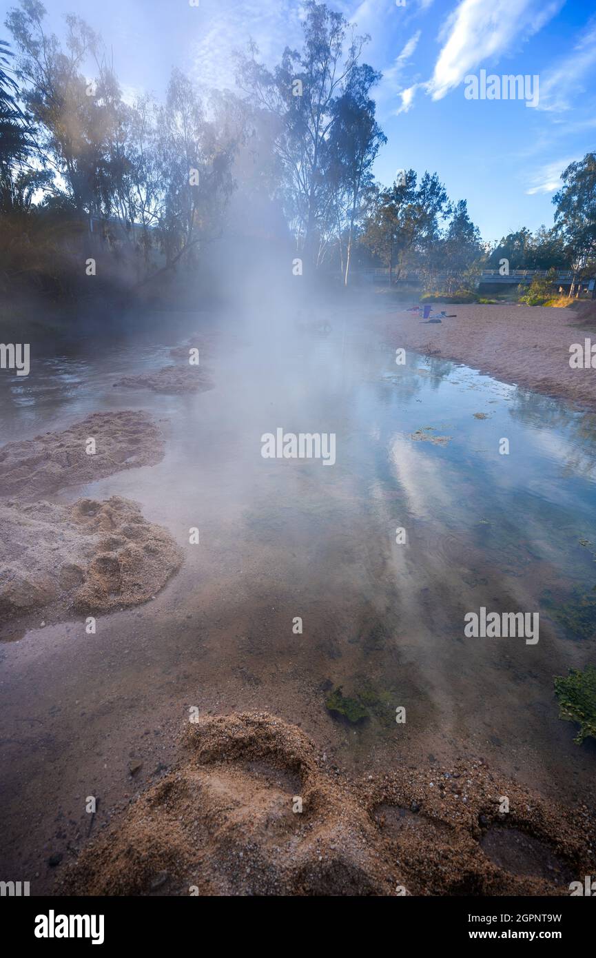 Steam rising at sunrise from the natural mineral hot water flowing in Nettle Creek, Innot Hot Springs, North Queensland Australia Stock Photo