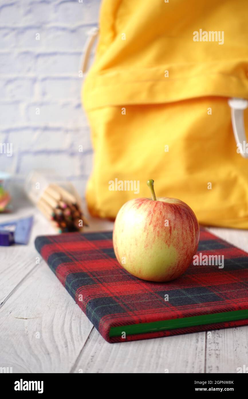 black to school concept with apple on notepad on table. Stock Photo