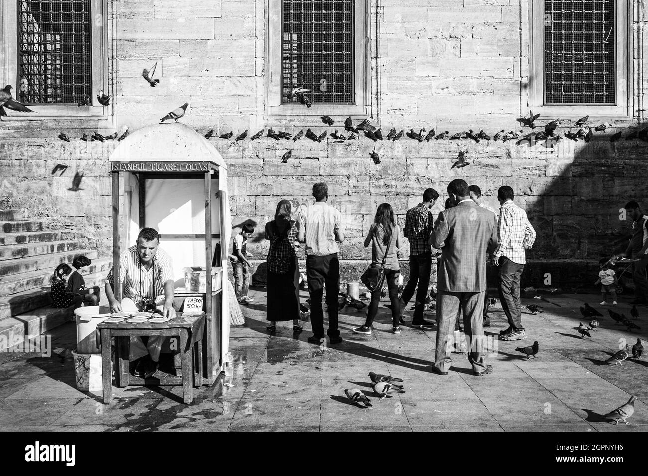 Istanbul, Turkey; May 27th 2013: People feeding pigeons. Stock Photo