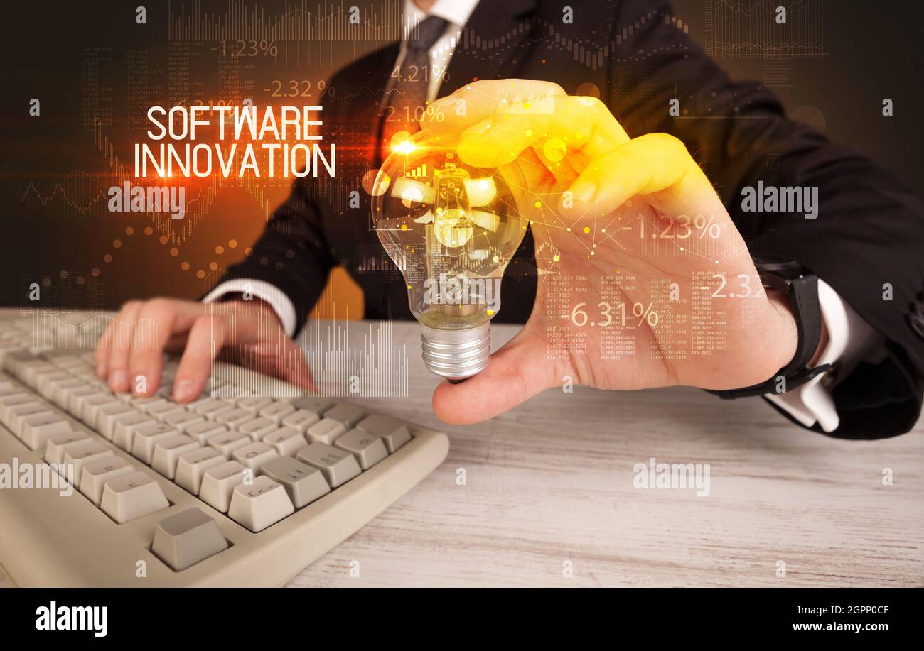 Businessman holding a lightbulb concept Stock Photo - Alamy