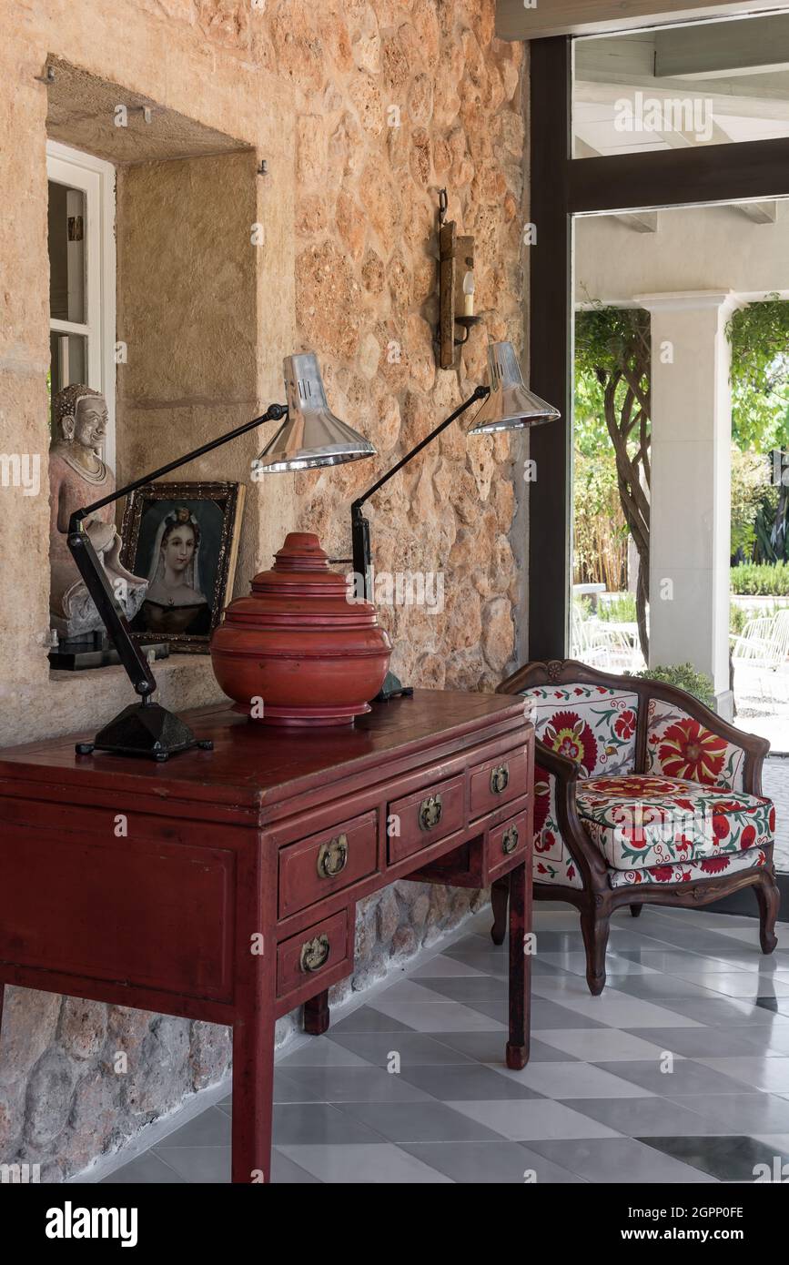 Chinese elm wood desk with Burmese pot and Indian teak armchair in Spanish villa, Mallorca Stock Photo