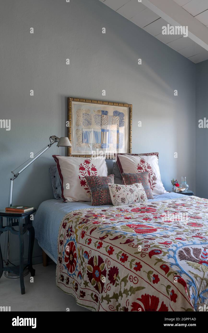Embroidered bedspread with block print cushions in Spanish villa, Mallorca Stock Photo Alamy