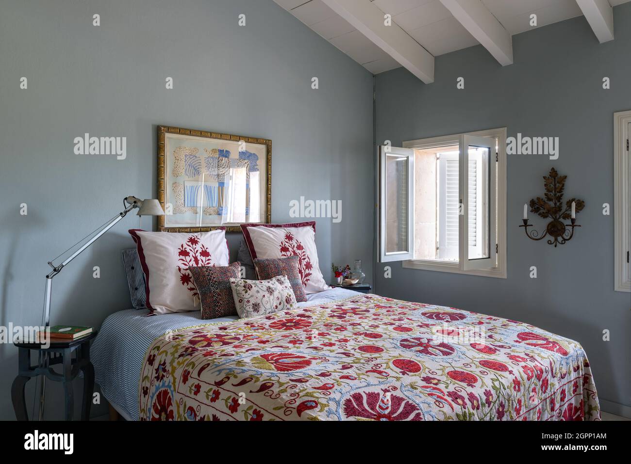 Embroidered bedspread with block print cushions in Spanish villa, Mallorca Stock Photo Alamy