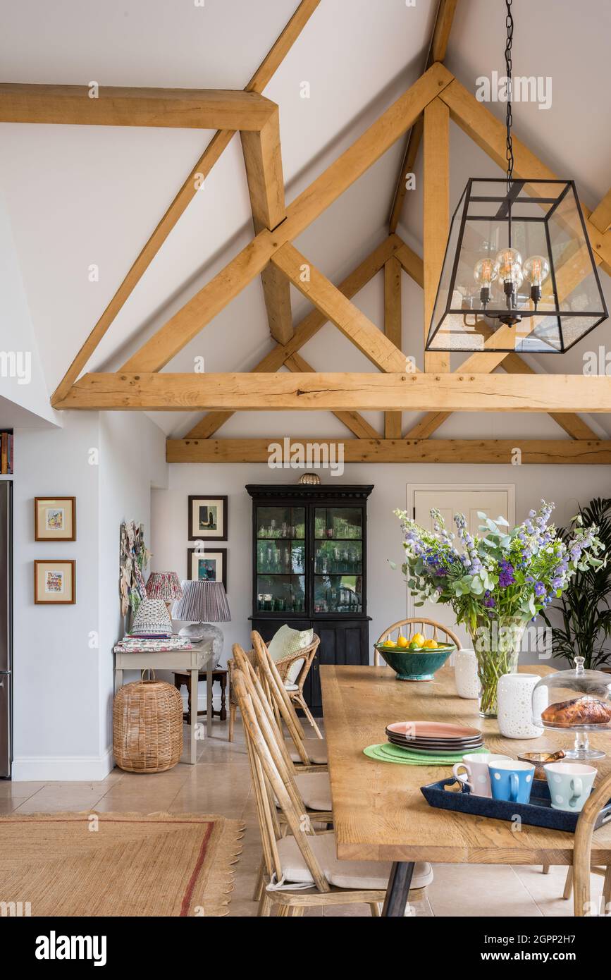 Dining table and chairs in oak beamed Hampshire extension, UK Stock Photo Alamy