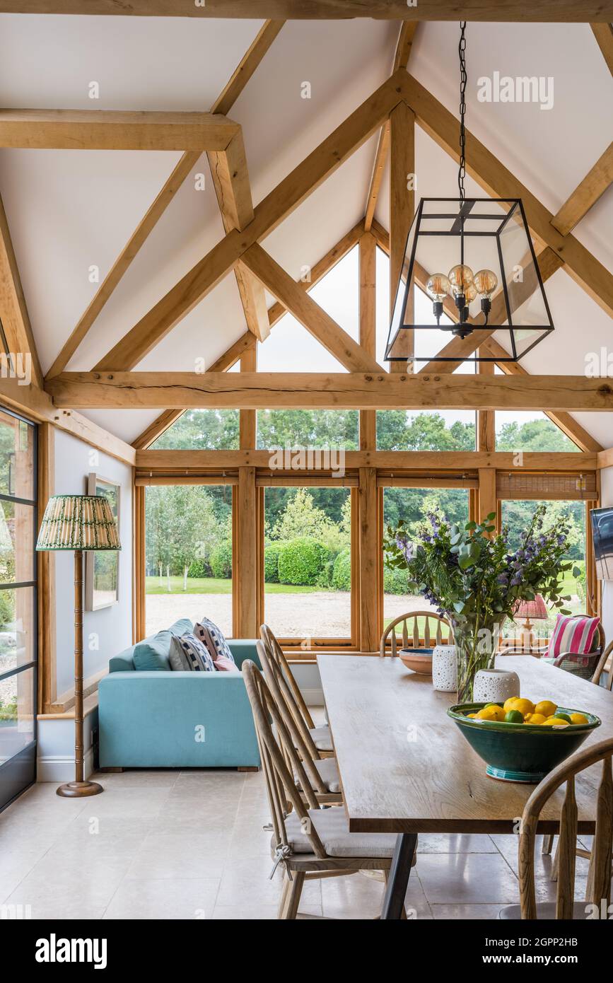 Dining table and chairs in oak beamed Hampshire extension, UK Stock Photo Alamy