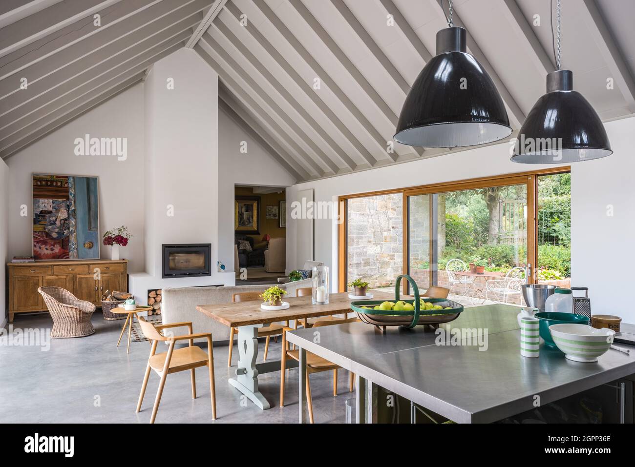 Pair of pendant shades above kitchen island in newly built Sussex farmhouse, UK Stock Photo