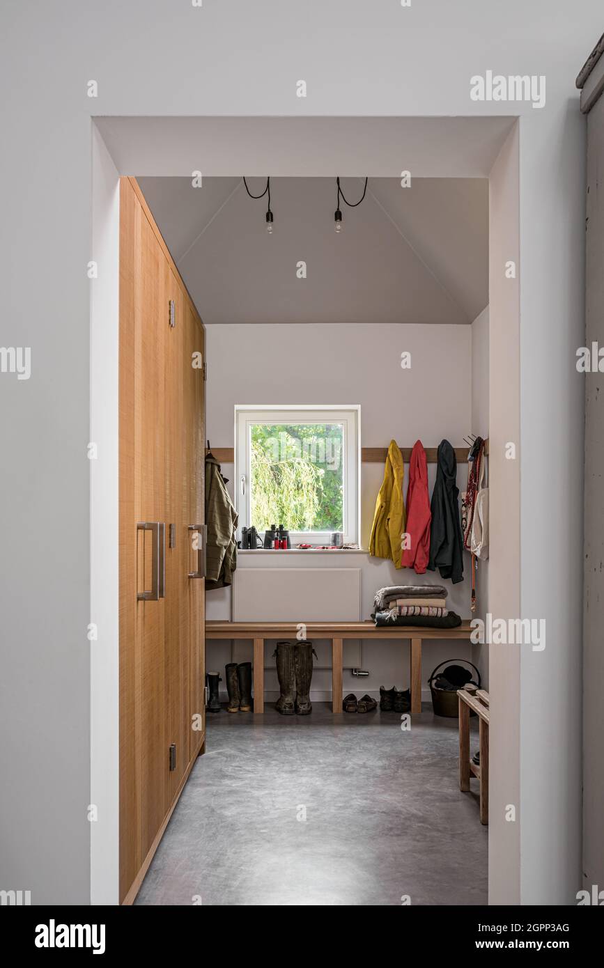 Claokroom with wooden doors and concrete floor in new build, Sussex, UK Stock Photo