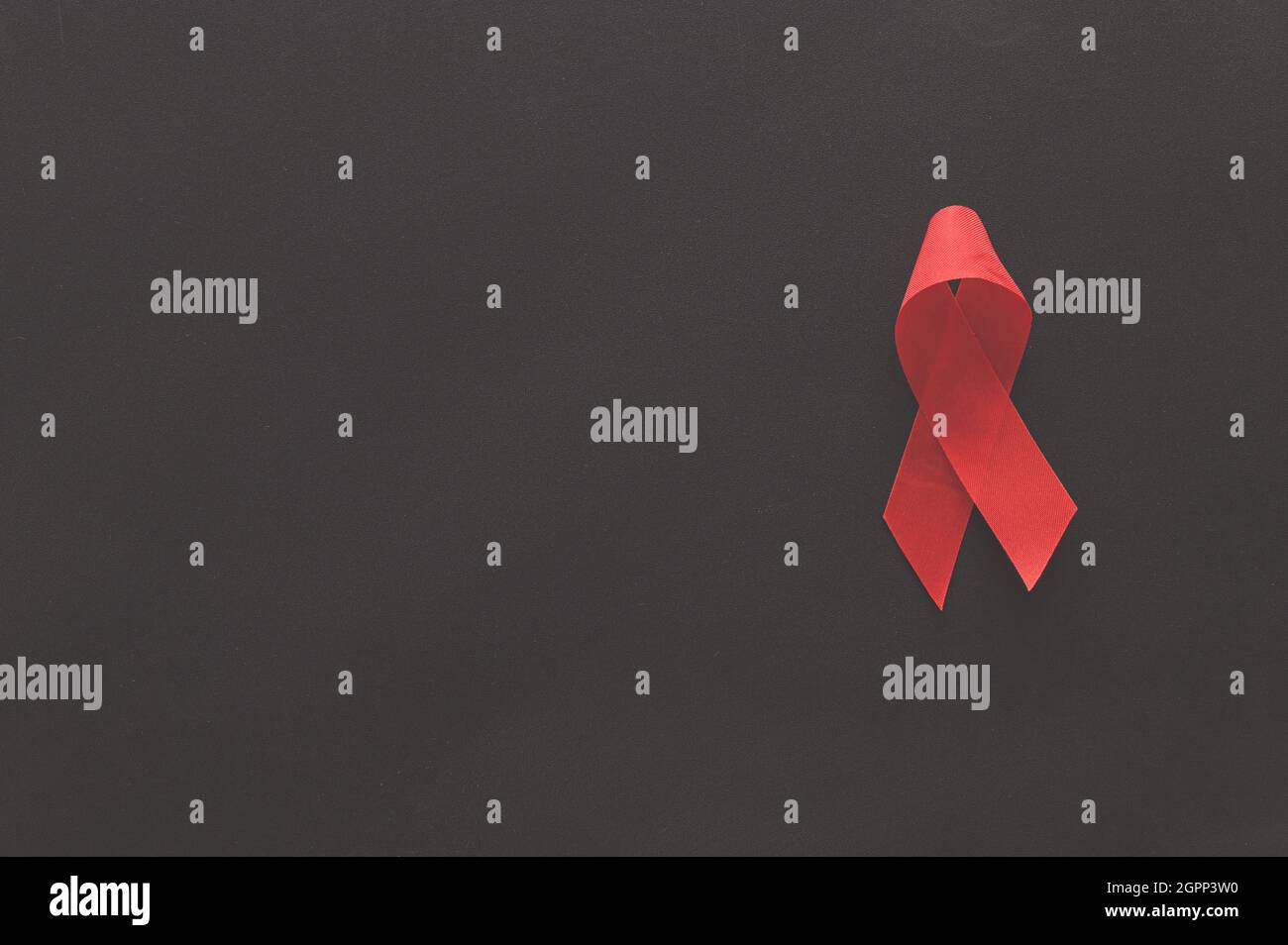 Red ribbon symbolizes world health day Stock Photo - Alamy