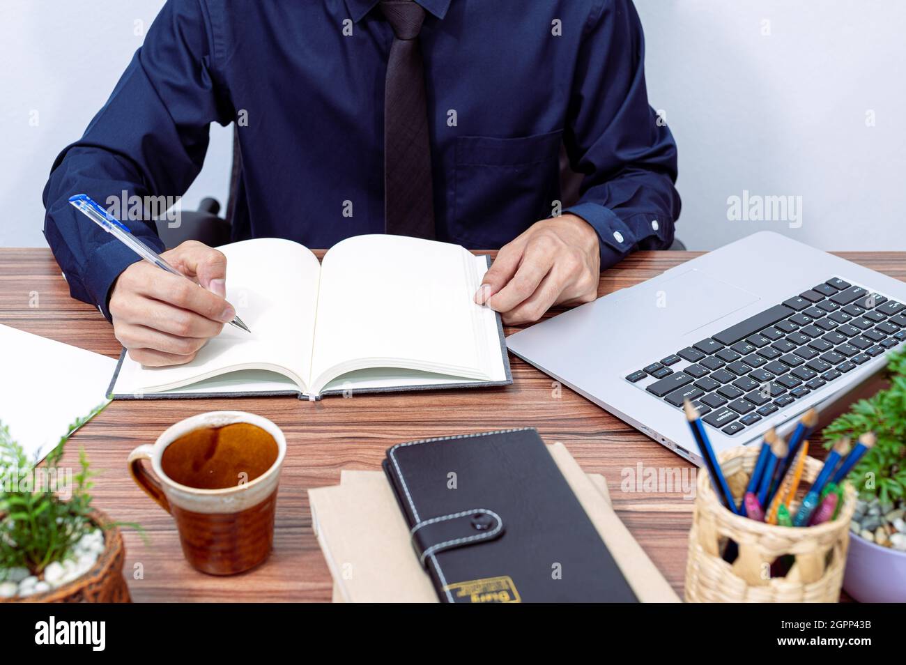 business man writing a report at his desk Stock Photo - Alamy