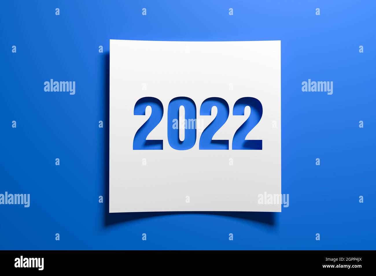 A piece of curved memo paper with the cut out number 2022 on blue background. Concept for events in the year 2022 and New Year 2022. Stock Photo