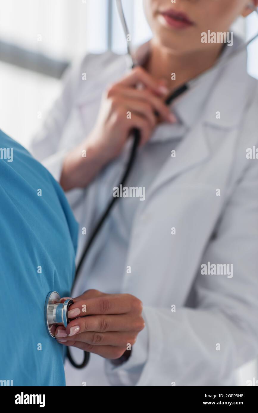 Doctor examining patient with stethoscope hi-res stock photography and ...