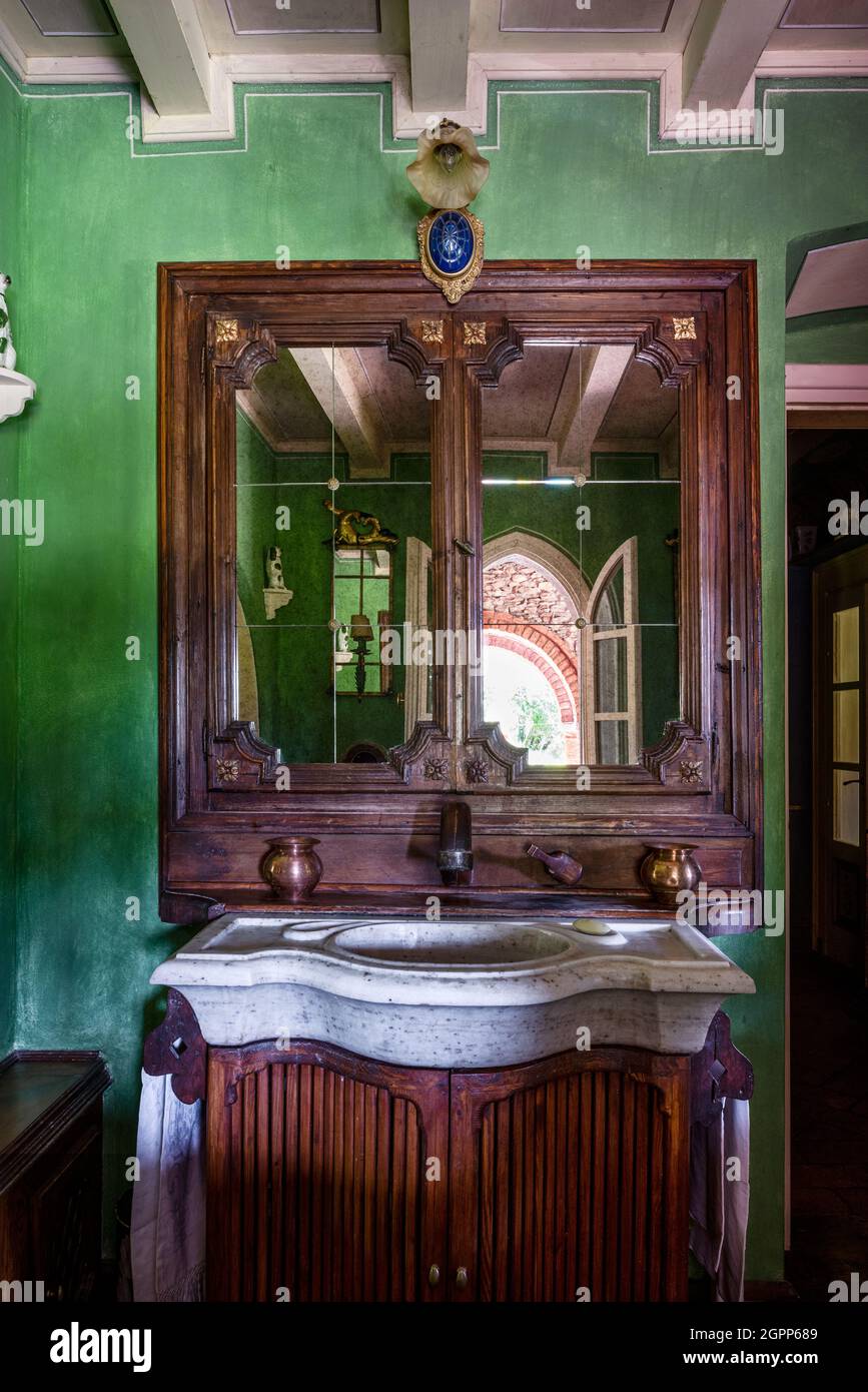 Antique wooden cabinet in green bathroom, Lake Garda. Stock Photo