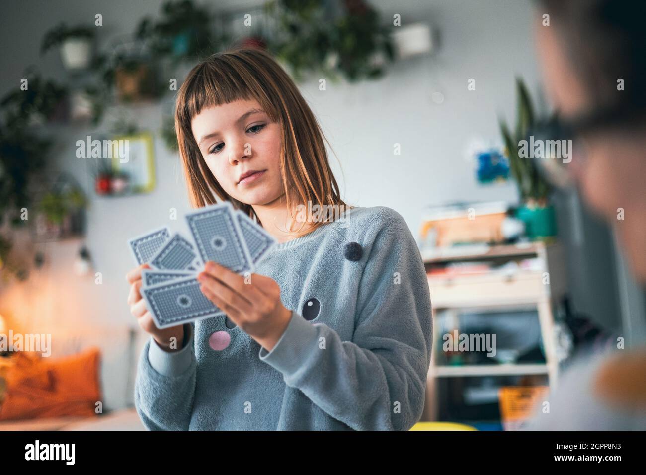 Girl playing cards at home Stock Photo Alamy