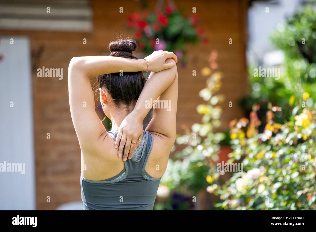 Rear view of woman stretching hi-res stock photography and images - Alamy