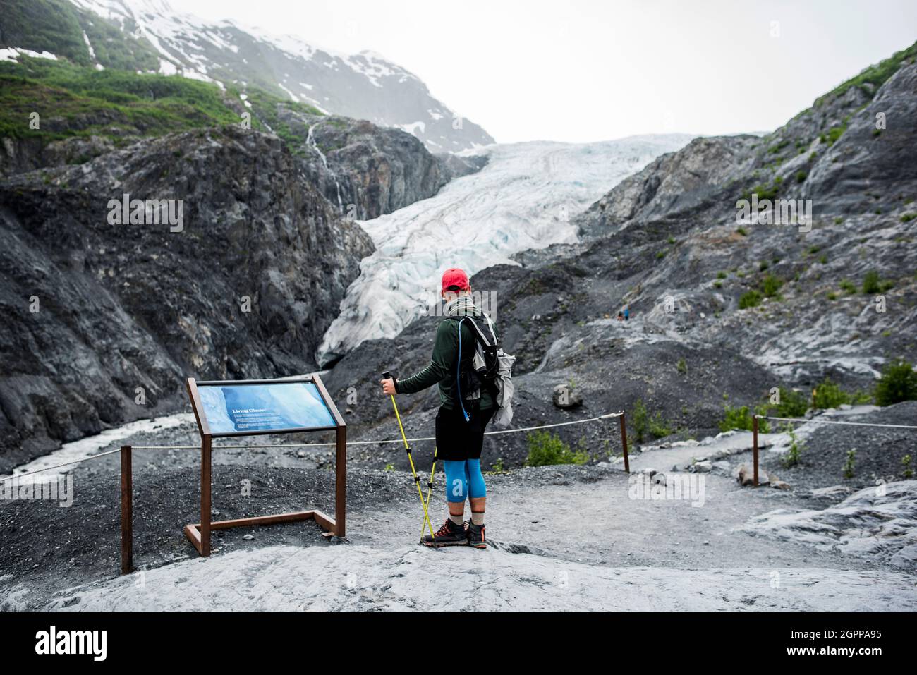 USA, Alaska, Rear view of hiker looking at glacier in Denali National Park Stock Photo