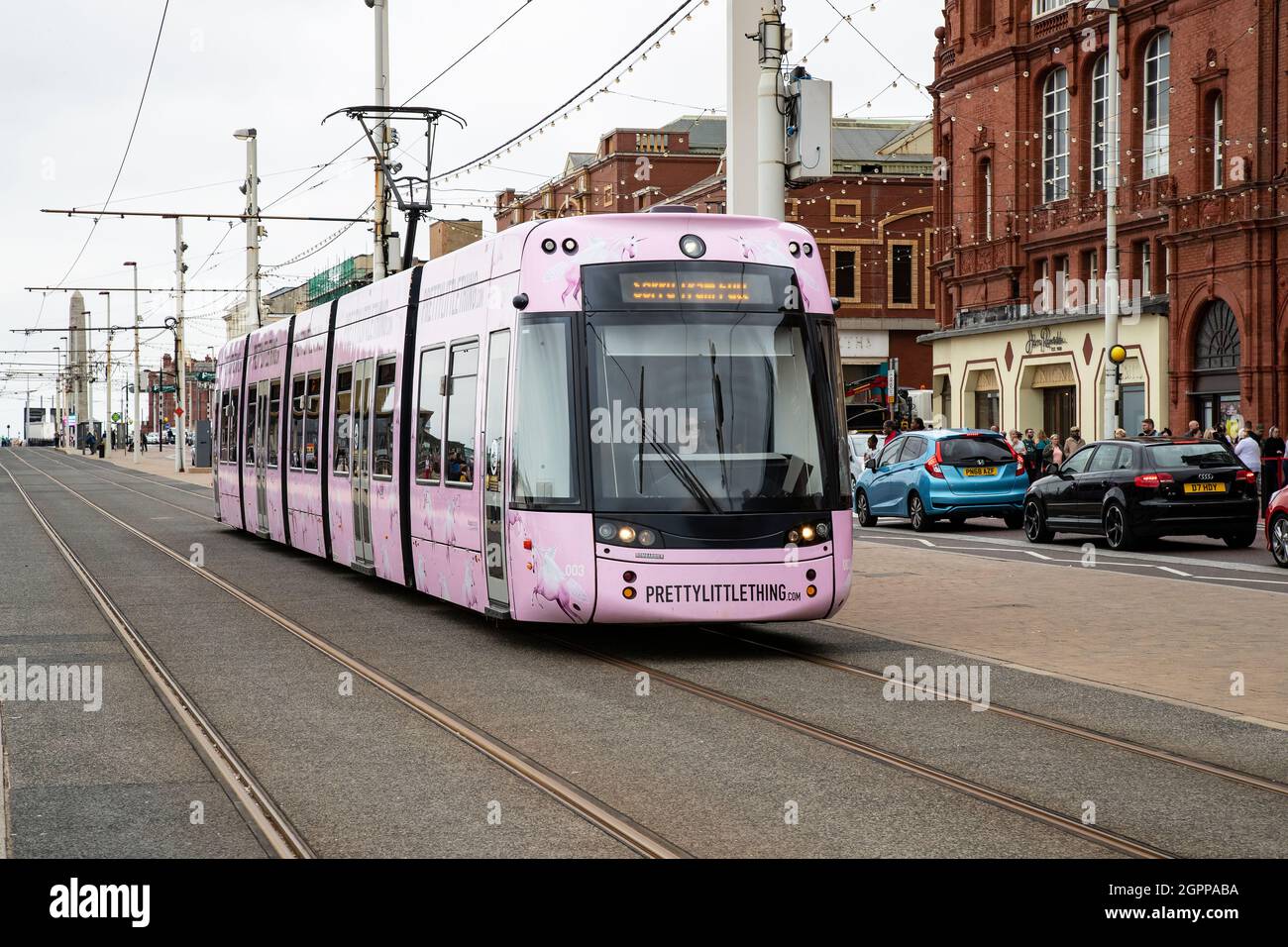 Bombardier Flexity 2 tram 003 in the Pink livery of the 'Pretty Little Thing' clothing store on Blackpool's seaside resort promenade on UK West coast Stock Photo
