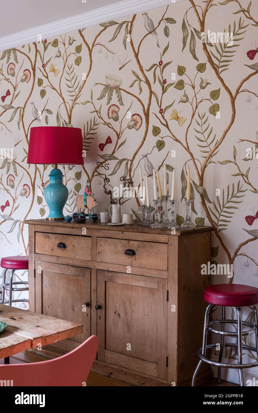 Tree of Life wallpaper with lamp on Welsh dresser in Suffolk cottage. Stock Photo