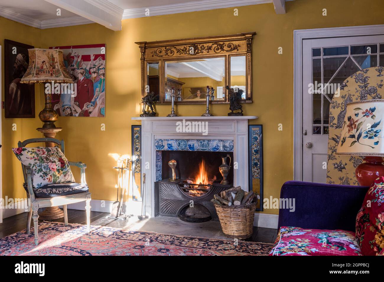 Georgian fire with Delft tiles and contrasting patterns in Suffolk living room. Stock Photo