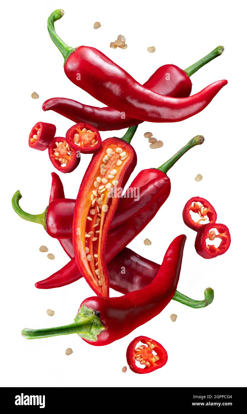 Fresh red chilli peppers and cross sections of chilli pepper with seeds