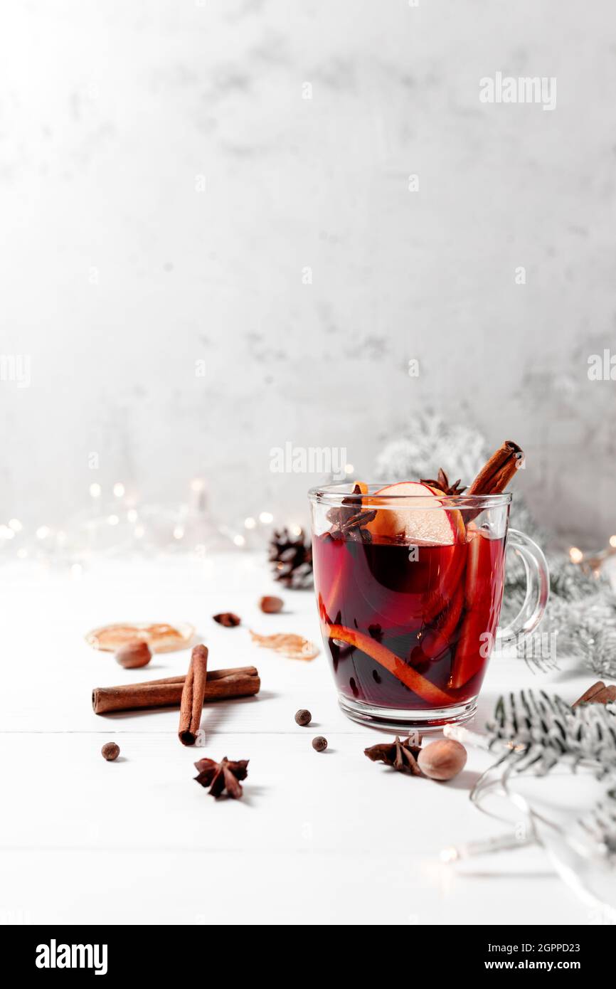 Christmas time. Glass cup of Mulled Wine on white gray concrete background table Stock Photo