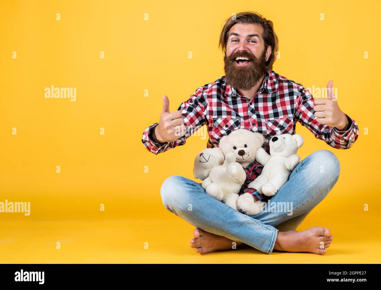 all for you. Guy with happy face plays with soft toy. Childish mood concept. guy enjoy valentines day. best present ever. Valentines day gift for Stock Photo
