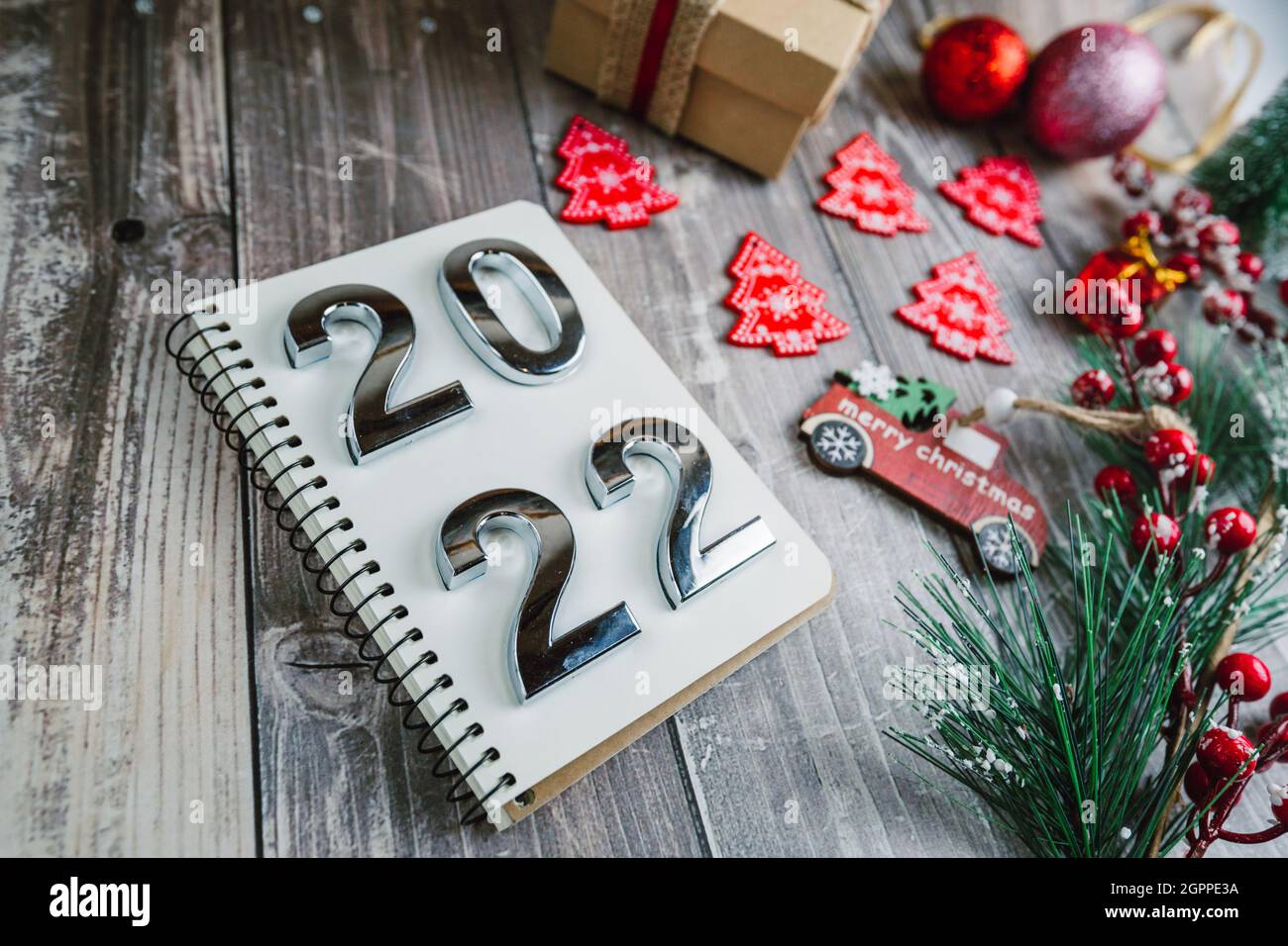 Its Christmas 2022 Pics Numbers 2022 On A Spiral Notepad On A Wooden Background With Christmas  Decorations Stock Photo - Alamy