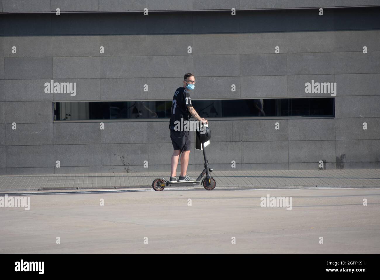 Man in suit on electric scooter hi-res stock photography and images - Alamy