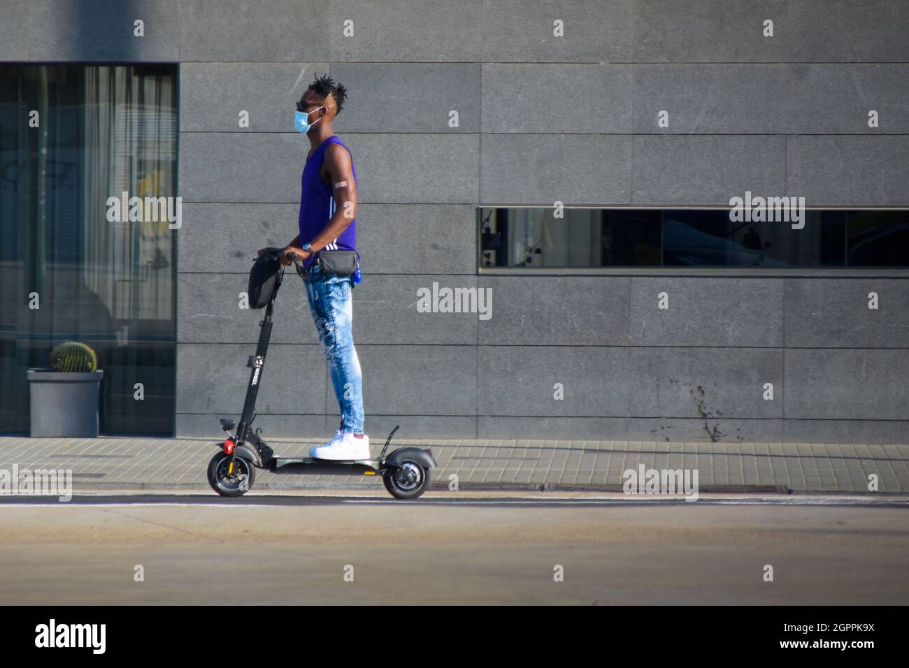 Man in suit on electric scooter hi-res stock photography and images - Alamy