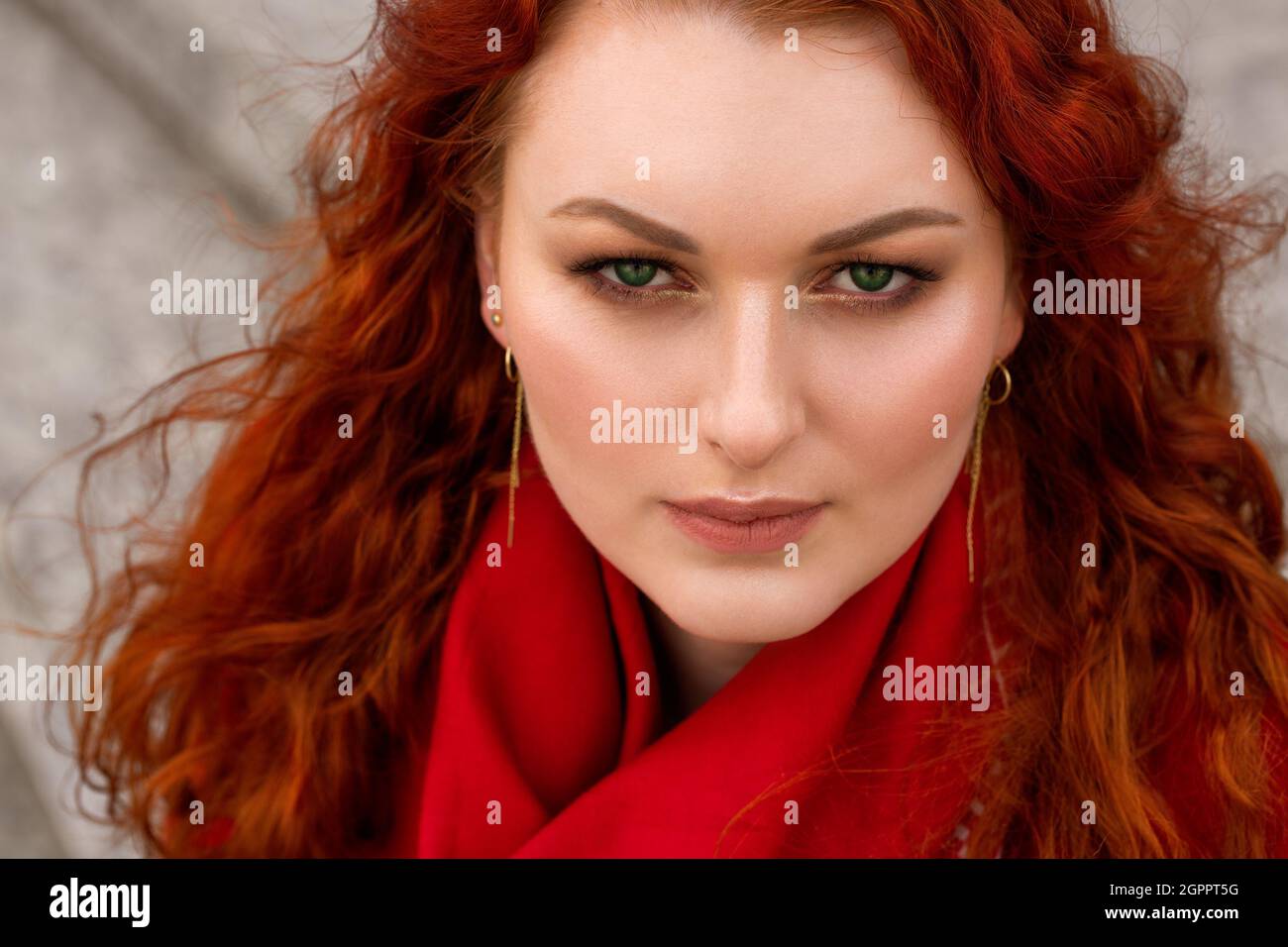 Portrait Of Woman With Red Hair And Bright Makeup. Beautiful Green Eyes. Red  Scarf Around The Neck Stock Photo - Alamy