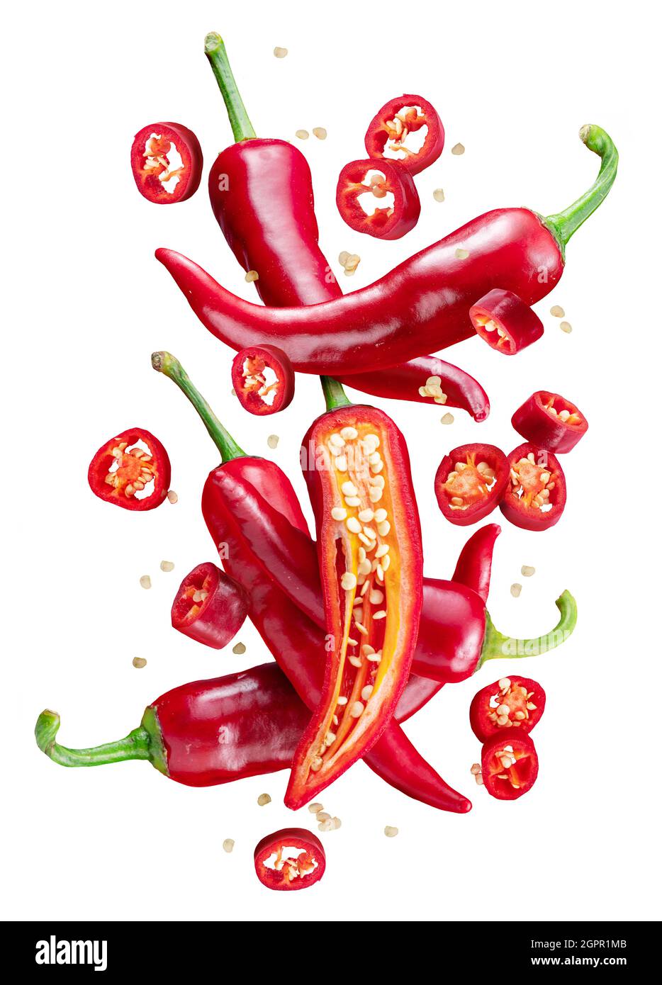 Fresh red chilli peppers and pepper slices floating in the air. File ...