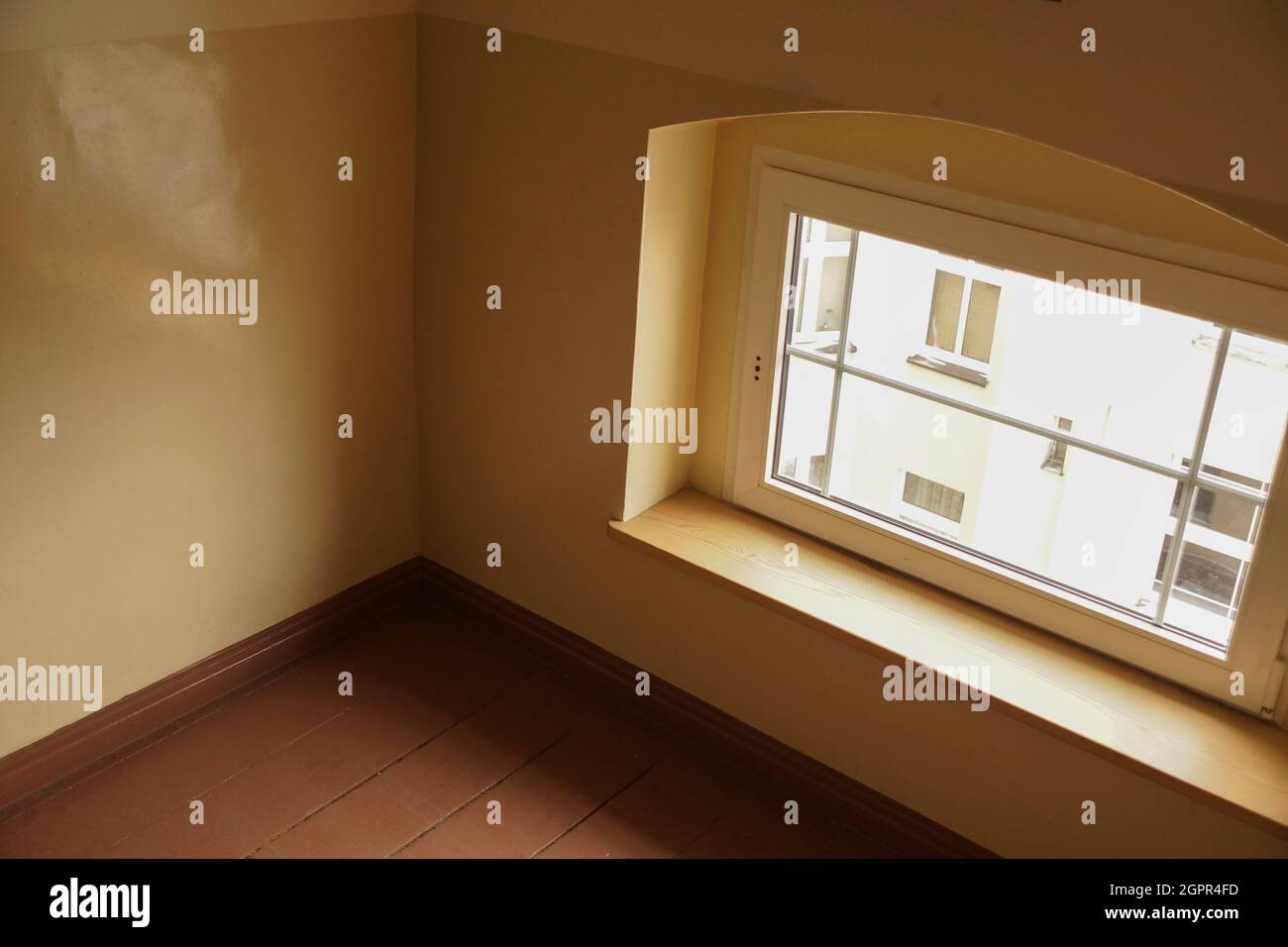 Small square window on the wall of the high rise apartment building ...