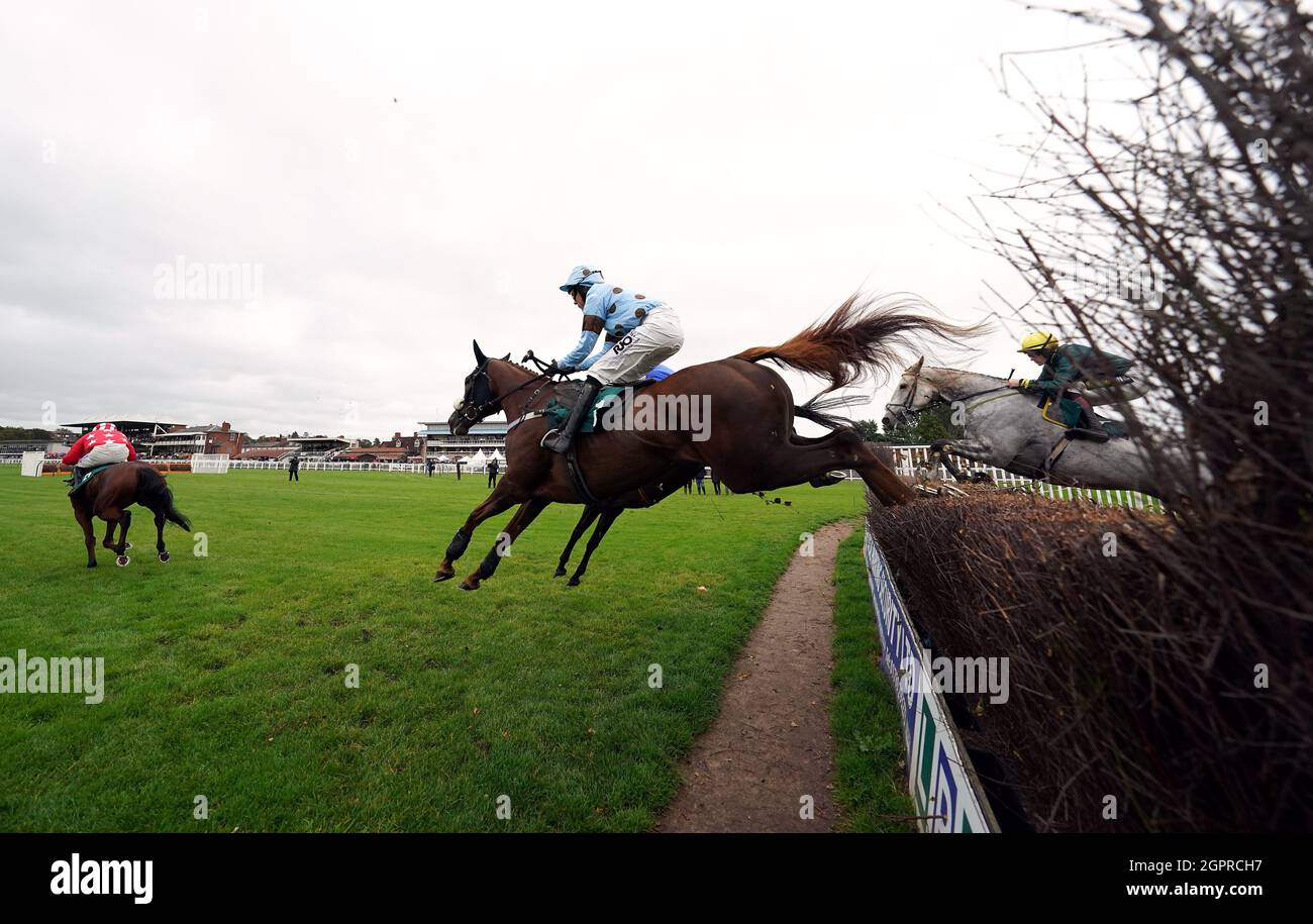 Fat Sam ridden by jockey James Davies (near side) clear a fence on their way to winning the Colliers Saves Business Rates Handicap Chase at Warwick Racecourse. Picture date: Thursday September 30, 2021. Stock Photo