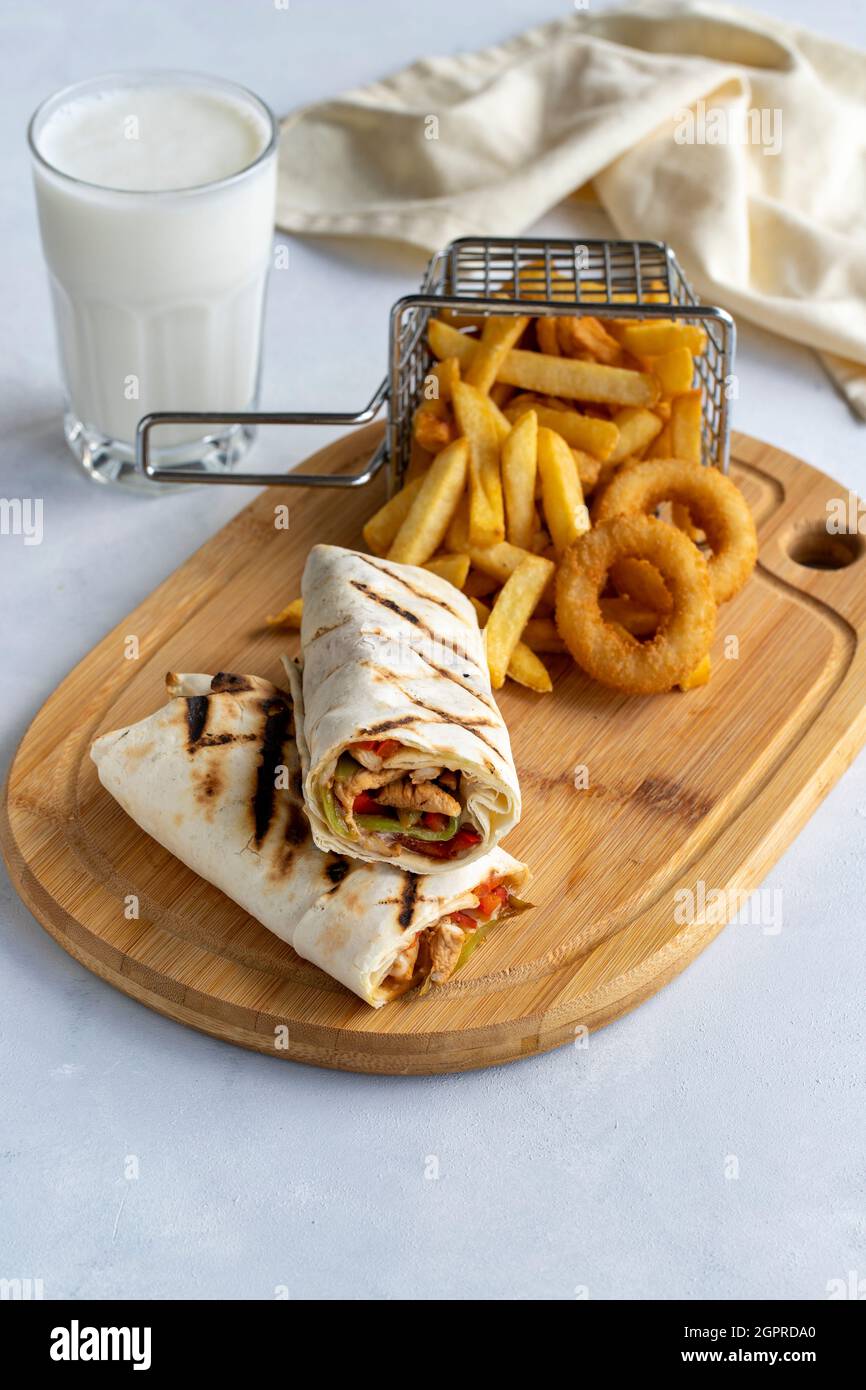 chicken-wrap-on-a-white-background-with-french-fries-and-onion-rings