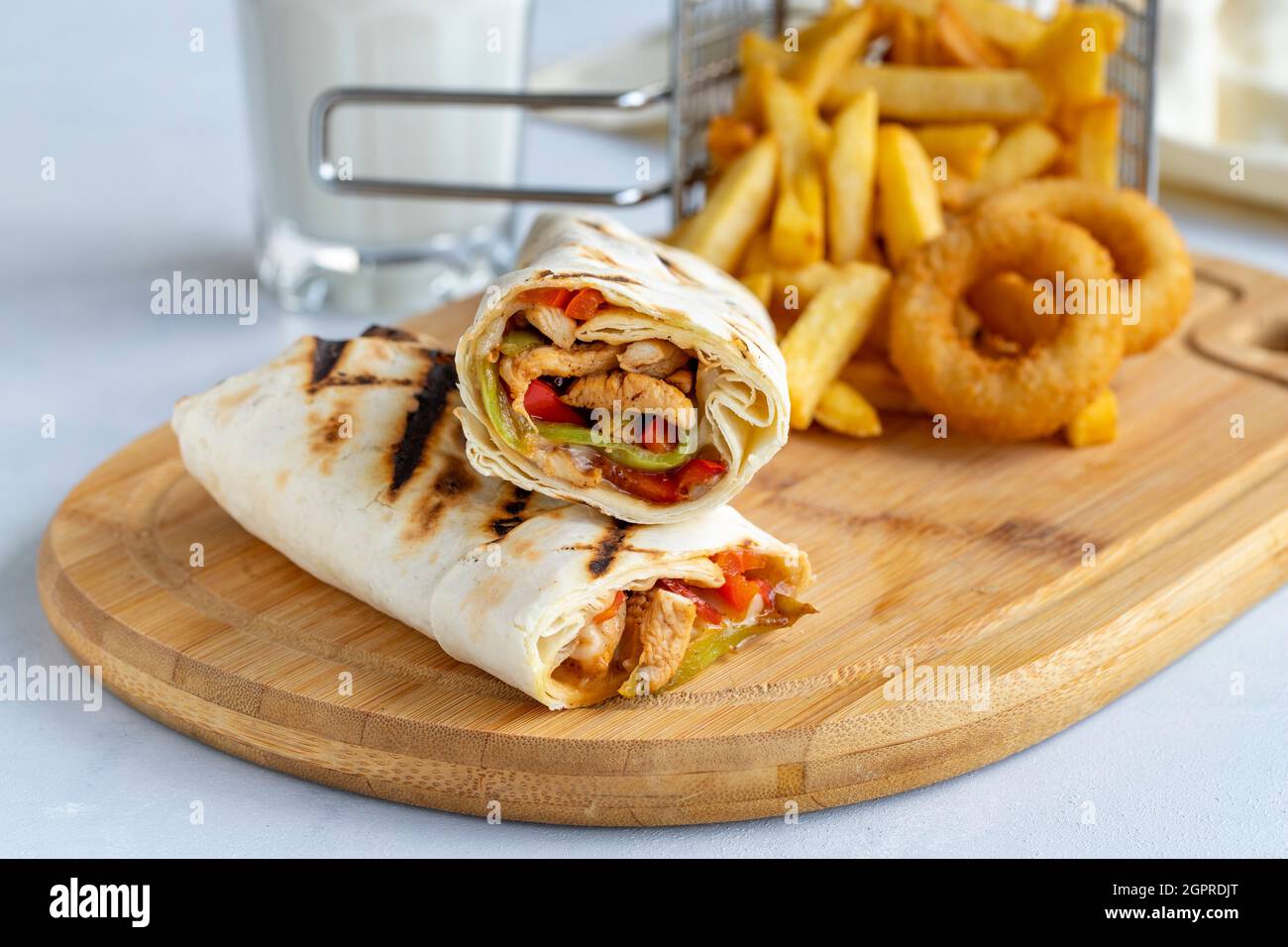 chicken-wrap-on-a-white-background-with-french-fries-and-onion-rings