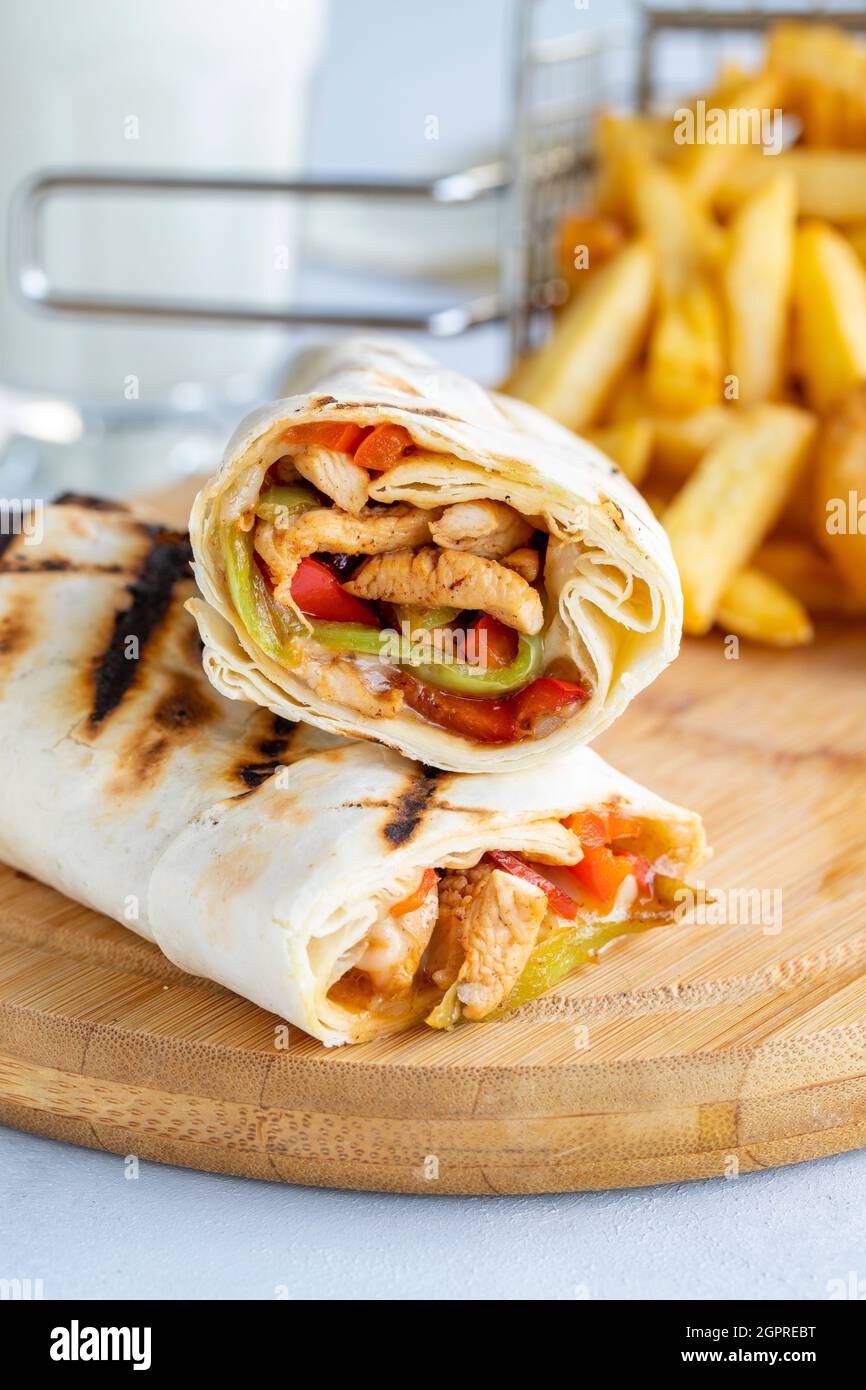 chicken-wrap-on-a-white-background-with-french-fries-and-onion-rings