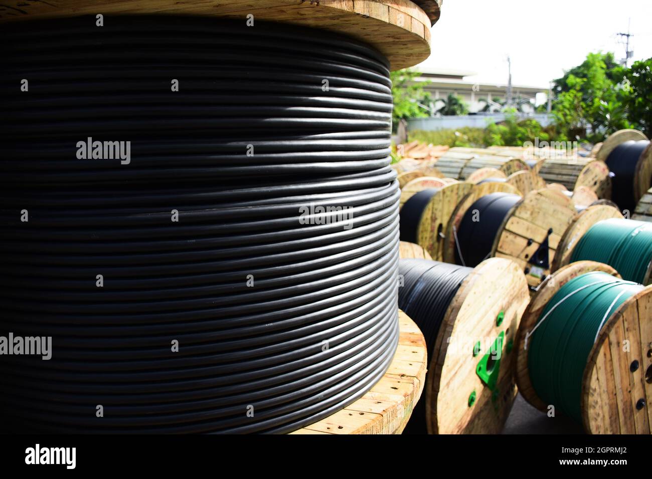 Wooden Coils Of Electric Cable Outdoor. High And Low Voltage Cables In