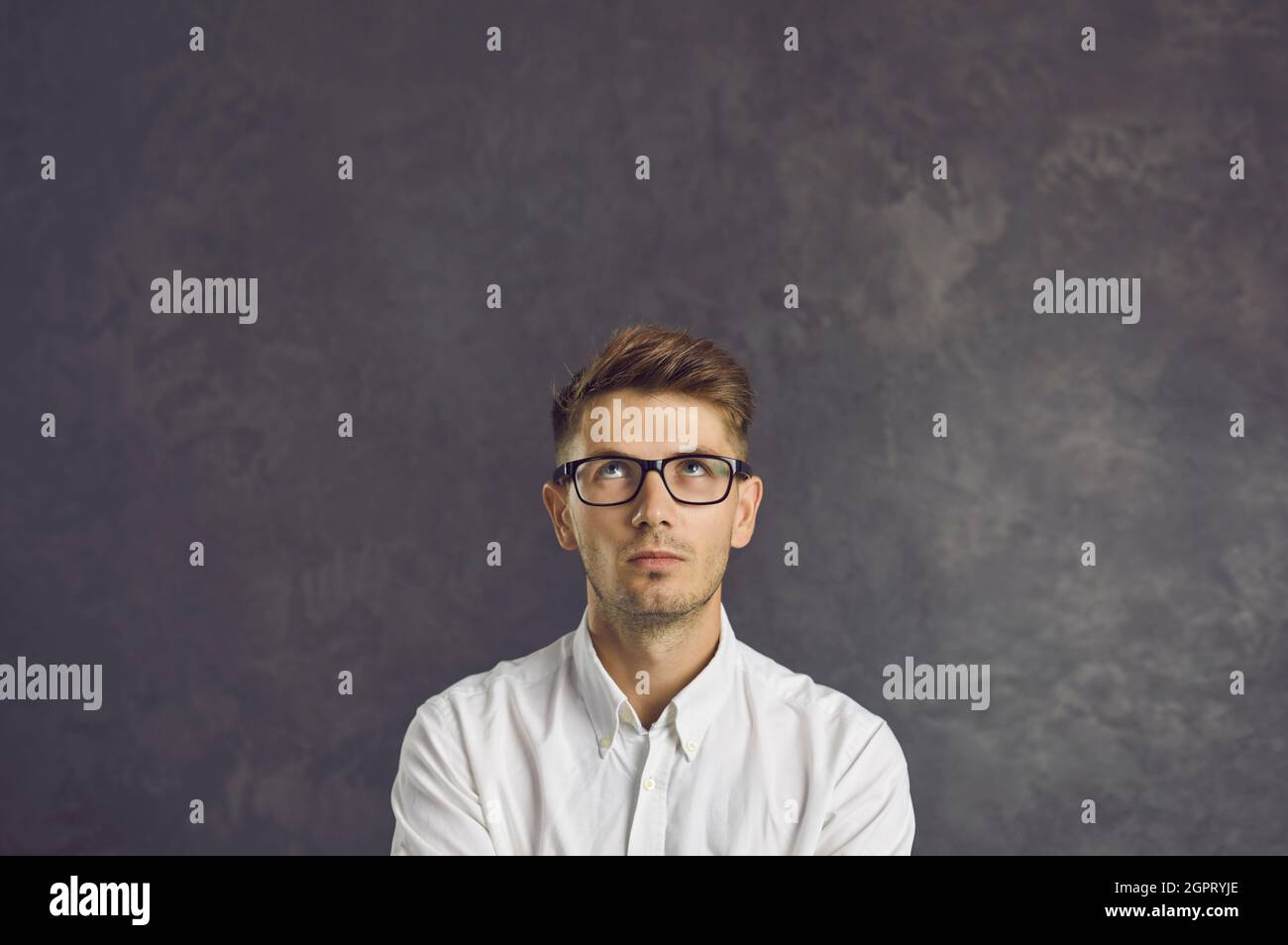 Young man look up on blank copy space Stock Photo