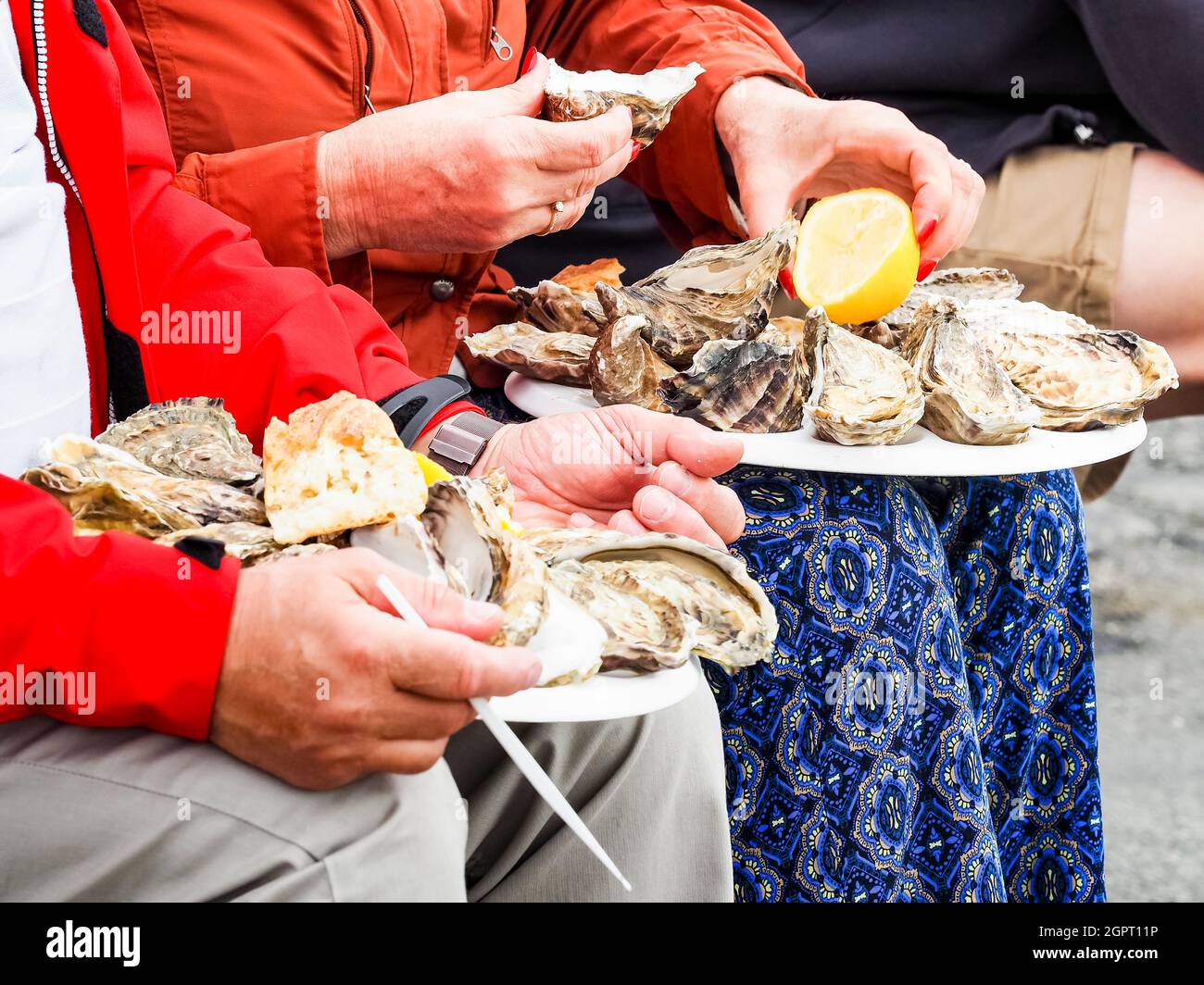 Midsection Of Man Holding Ice Oyster On The Knees, Ready To Eat Stock Photo