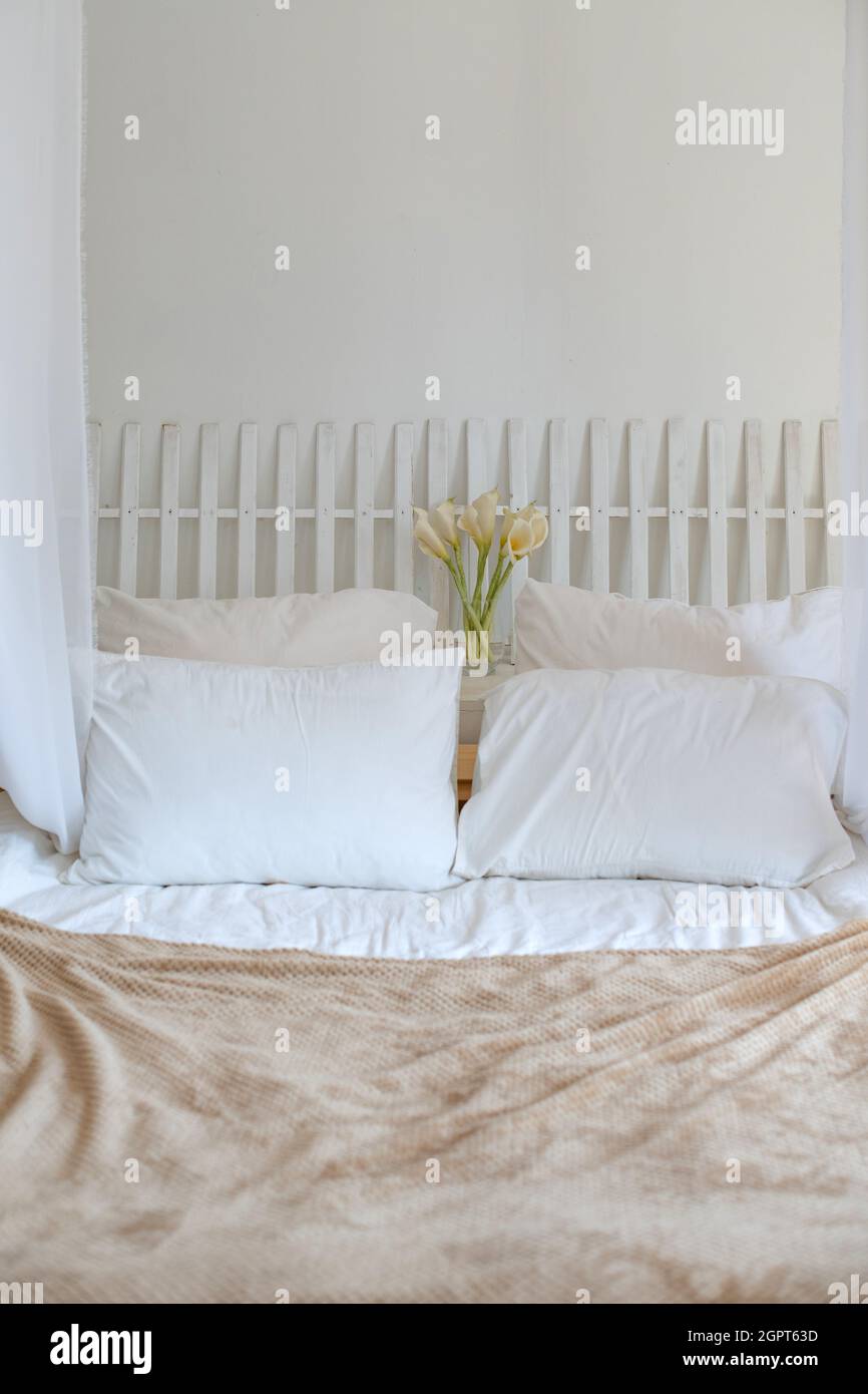 Pillows On Bed Against Wall At Home Stock Photo Alamy