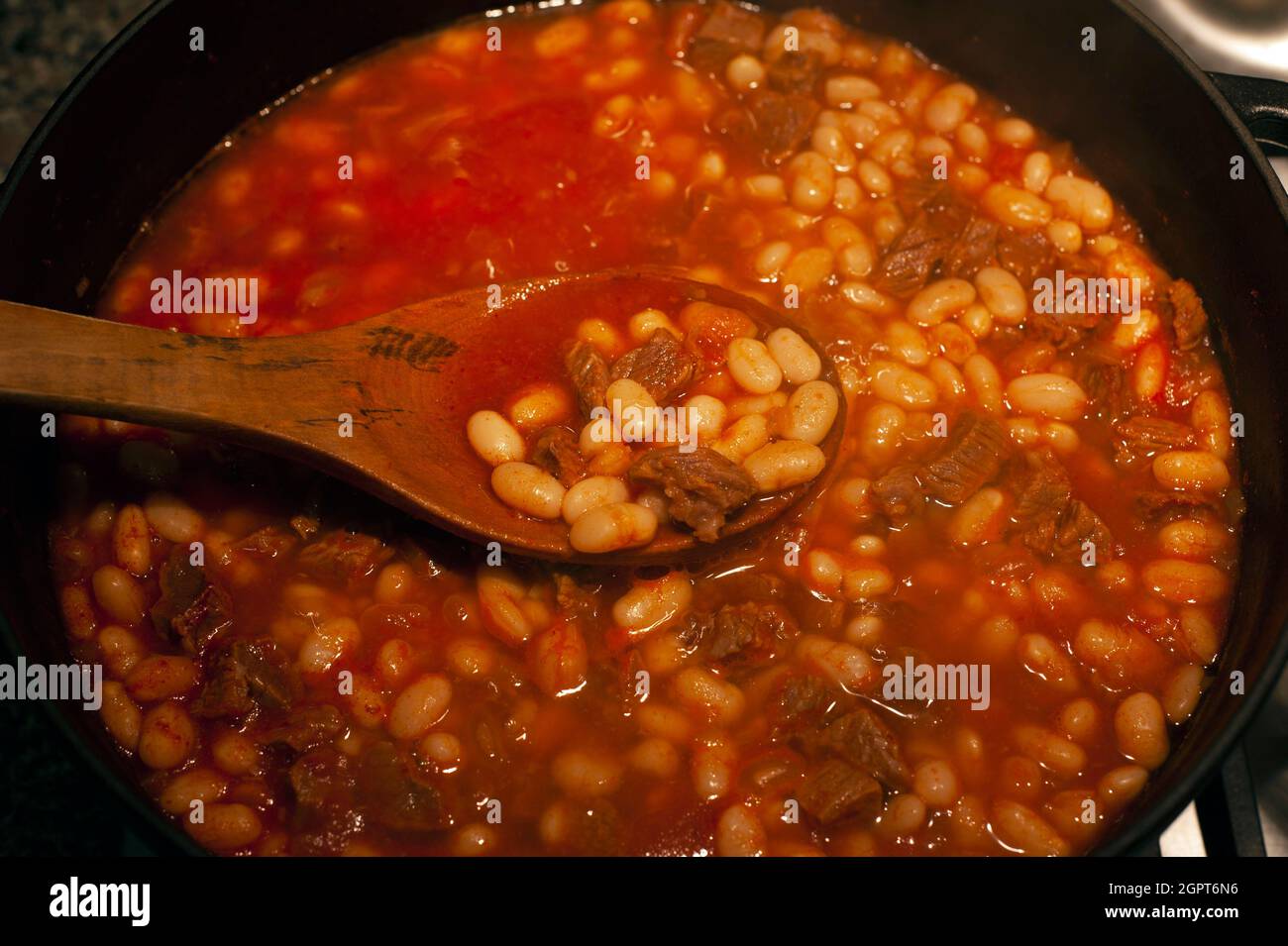 Bean meal with meat in a cast iron pot Stock Photo Alamy