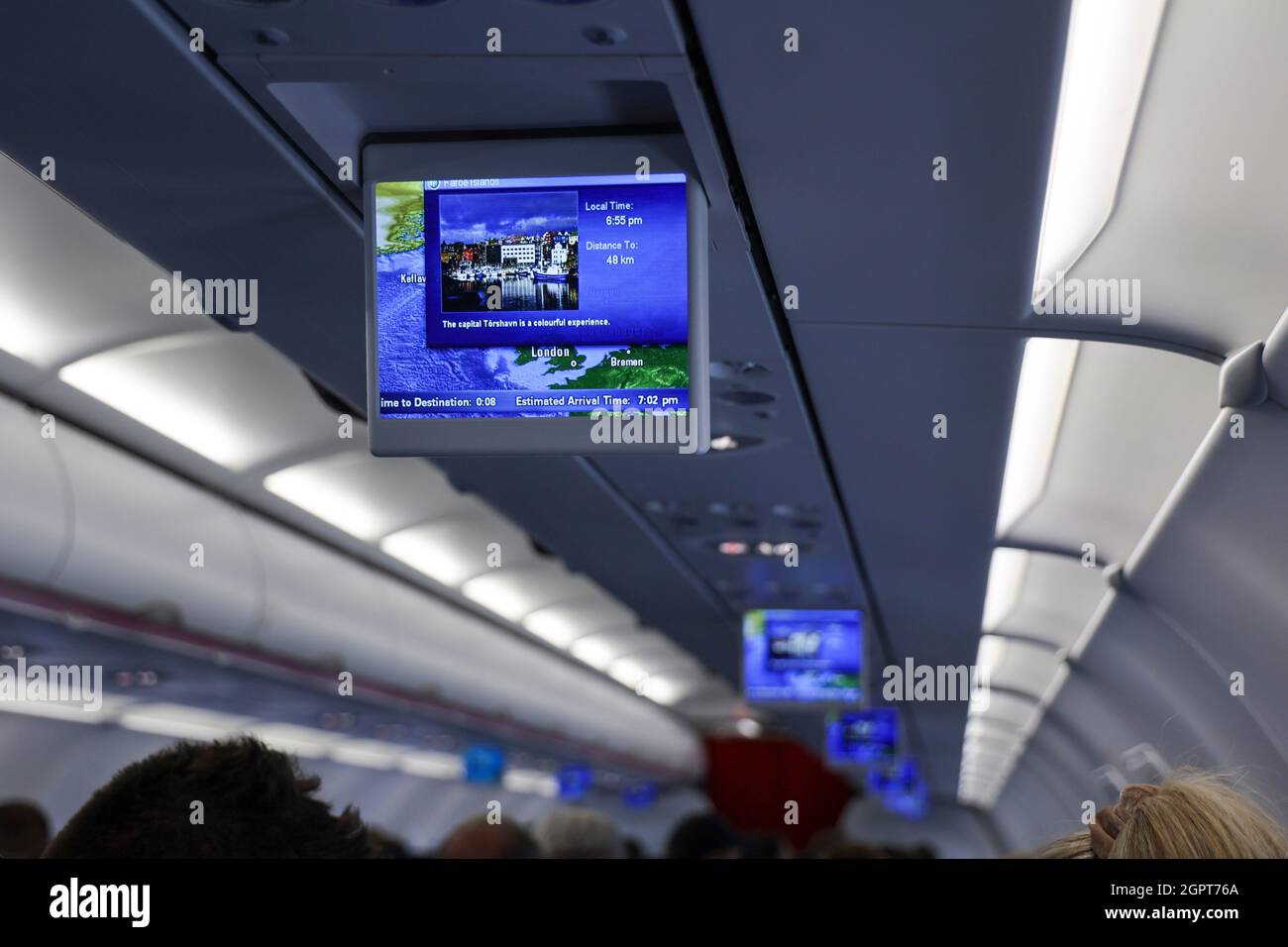 Monitor inside an aircraft cabin showing a picture of Torshavn, capital city of Faroer Islands shortly before landing at Vagar Airport, Faroer Islands Stock Photo
