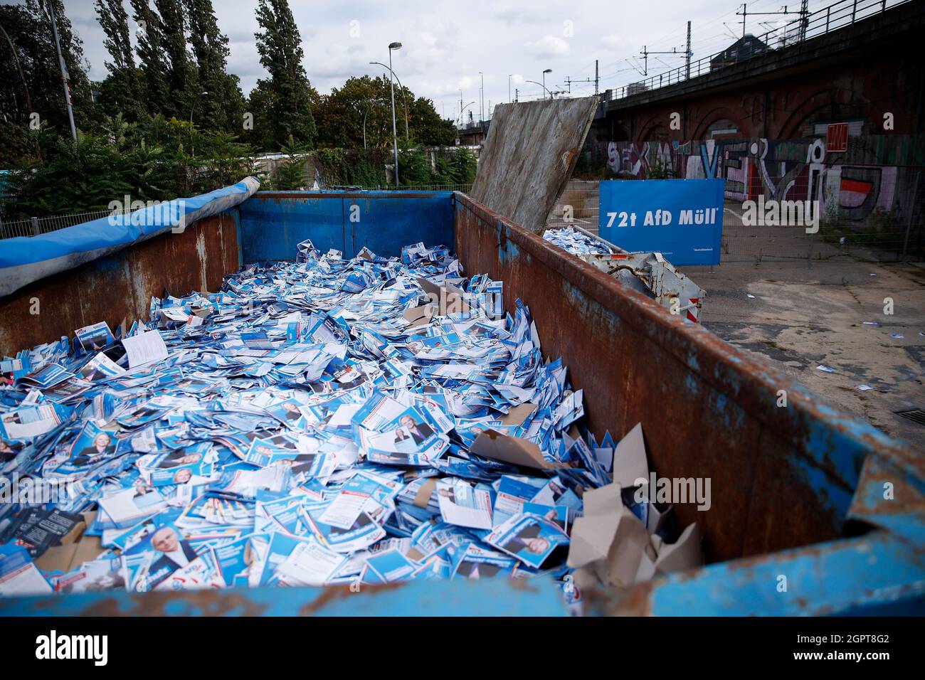 Berlin, Germany. 30th Sep, 2021. Visitors inspect displayed containers with AfD election campaign flyers at an open day at a recycling yard. In the containers, non-distributed AfD election campaign flyers are publicly displayed. The artist group 'Zentrum für Politische Schönheit' (ZPS) has declared itself responsible for a fictitious flyer service. Credit: Carsten Koall/dpa/Alamy Live News Stock Photo