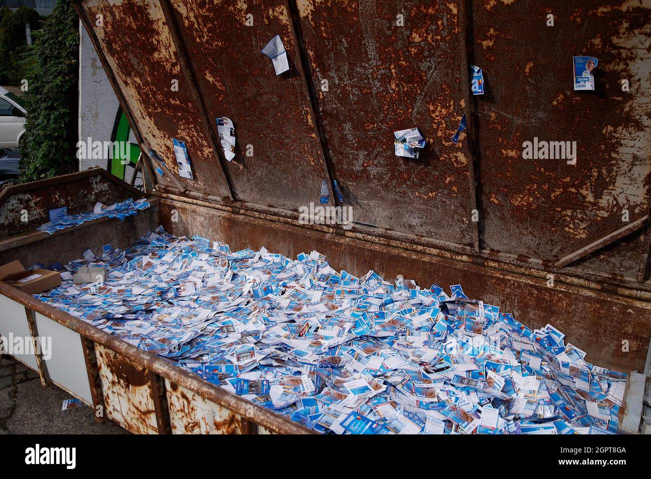 Berlin, Germany. 30th Sep, 2021. Containers with AfD election campaign flyers are displayed at an open day at a recycling yard. In the containers, non-distributed AfD election campaign flyers are publicly displayed. The artist group 'Zentrum für Politische Schönheit' (ZPS) has declared itself responsible for a fictitious flyer service. Credit: Carsten Koall/dpa/Alamy Live News Stock Photo