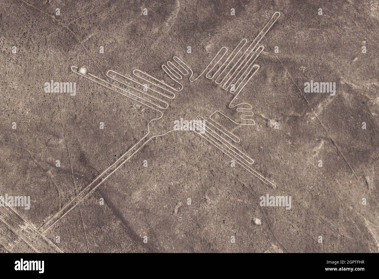Aerial view of geoglyphs near Nazca - famous Nazca Lines, Peru. In the center, Hummingbird figure is present Stock Photo