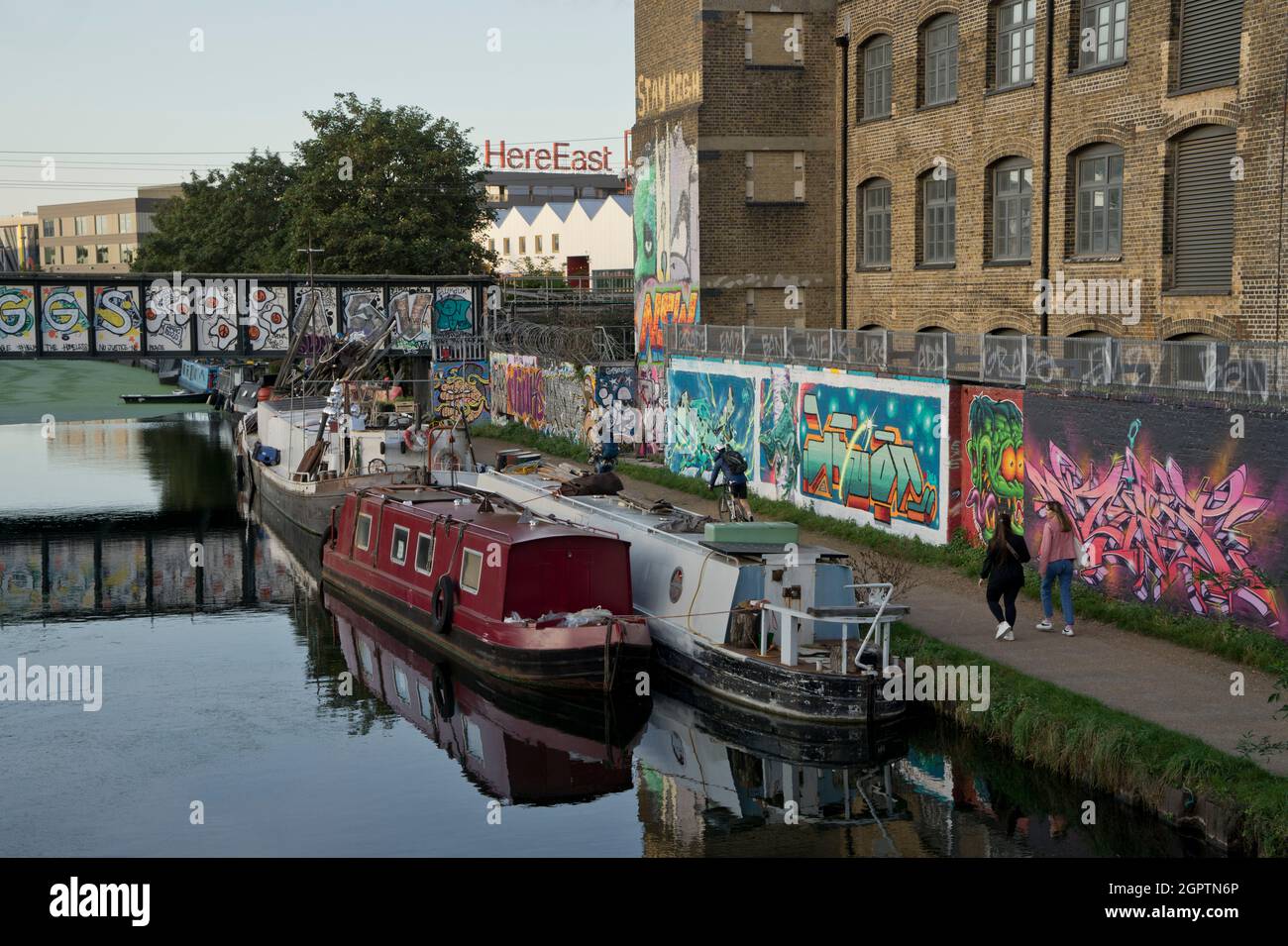 Old pub and warehouse studios by the Lea river canal with graffiti art