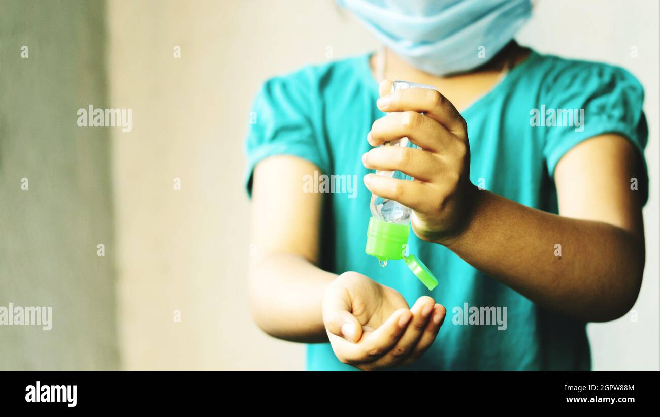 Child Uses Hand Sanitizer Stock Photo
