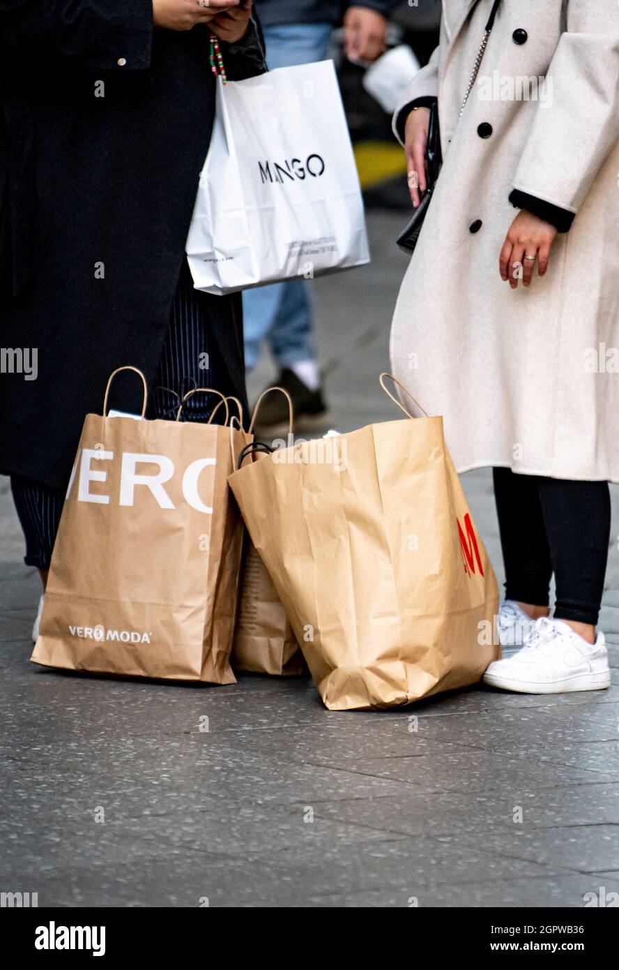 Berlin, Germany. 30th Sep, 2021. Two women stand with shopping bags in a  shopping centre. Inflation in Germany exceeded the four percent mark in  September for the first time in almost 28