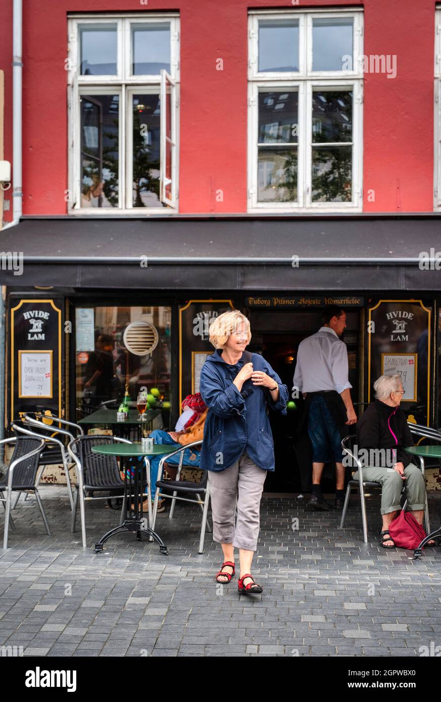 Blonde woman crossing a street in Copenhagen Stock Photo