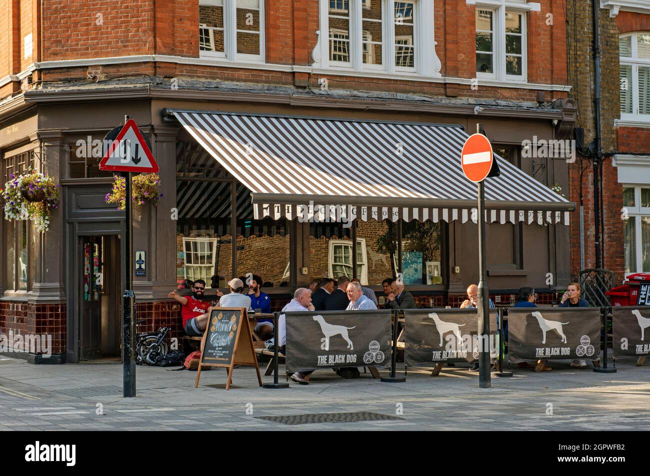 The Black Dog Public House or pub with people outside Vauxhall Stock